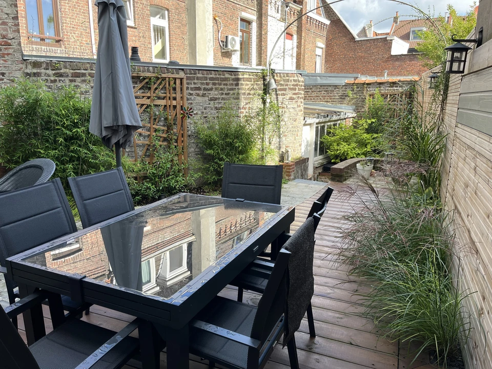 Aménagement paysager extérieur avec pelouse aux courbes organiques serpentant dans une allée de gravier gris